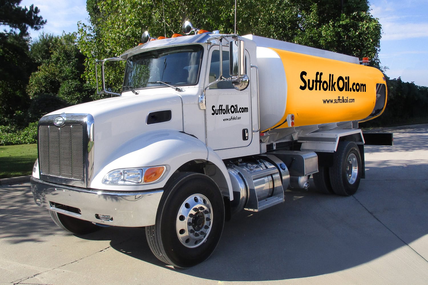 A Suffolk Oil branded fuel delivery truck parked outdoors, with visible company logo and fuel hoses.