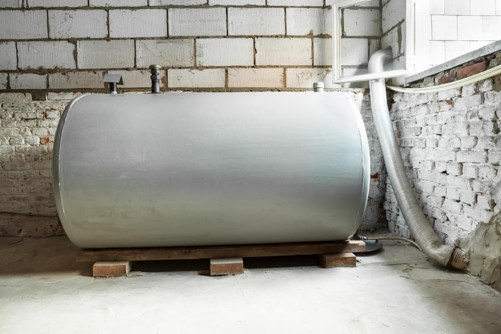 A large heating oil storage tank, typically made of steel or plastic, used to hold fuel for a home or building’s heating system.